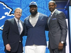 Alabama's A'Shawn Robinson, centre, poses for photos with NFL commissioner Roger Goodell and former NFL player Herman Moore after being selected by Detroit Lions as 46th pick in the second round of the NFL Draft, Friday, April 29, 2016, in Chicago.