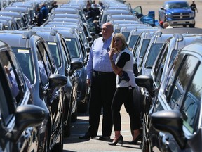 Auburn Hills, Michigan.  April 27, 2016 -- Bridget Reinberger, right, and John Wilde, both of Cincinnati, Ohio, study Windsor-built 2017 Chrysler Pacifica minivans during a mass launch from the Palace of Auburn Hills to auto dealerships in Michigan, Ohio, Kentucky and Indiana, April 27, 2016. (NICK BRANCACCIO/Windsor Star)