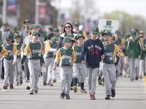 Members of the LaSalle Titans rookie minor division walk down Front Rd. in the Turtle Club Baseball Parade to celebrate their opening day on April 30, 2016.