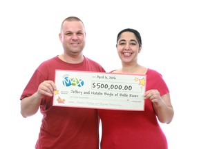 Jeffery and Natalie Boyle show off the $500,000 cheque they received from a Maxmillions draw. They intend to use the funds for their family.