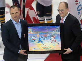 CARHA World Cup president Mike Peski, left, presents Windsor Mayor Drew Dilkens with a picture on April 8, 2016, before the feature match at the WFCU Centre in Windsor, Ont.
