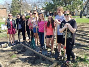 Herman Secondary School students prepare a community garden in Windsor, Ont. during the launch of the United Way Centraide ChangeTheWorld challenge.   More than 750 students from four school boards will be preparing and planting 18 community gardens across the city and county.