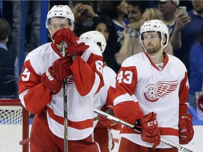 Detroit Red Wings Danny DeKeyser, left, and Darren Helm react to the team's 1-0 loss to the Tampa Bay Lightning in Game 5 Thursday in Tampa, Fla. The Lightning won the series 4-1.