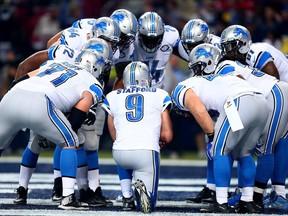 The Detroit Lions offensive unit huddles around quarterback Matthew Stafford in the second quarter against the St. Louis Rams at the Edward Jones Dome on December 13, 2015 in St. Louis, Mo.