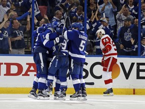 Members of the Tampa Bay Lightning celebrate as Niklas Kronwall #55 of the Detroit Red Wings reacts during the third  period in Game 2 of the Eastern Conference Quarterfinals at Amalie Arena on April 15, 2016 in Tampa, Fla.
