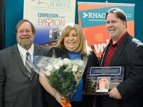 Marylynn Holzel, middle, Grant Fairley, left, and John Fairley, right, pose for a photo after Holzel received the 2016 Lois Fairley Nurse of the Year Community Service Award in Windsor, Ontario on Tuesday, April 12, 2016.