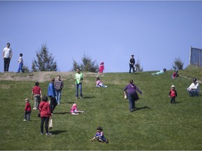 Kids and their parents play on the hill at Malden Park on Sunday, April 24, 2016, where hundreds gathered to celebrate Earth Day.
