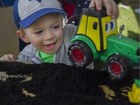 Paul Lefaive, 3, plays in the fresh dirt at Malden Park, Sunday, April 24, 2016, where hundreds came out to celebrate Earth Day.