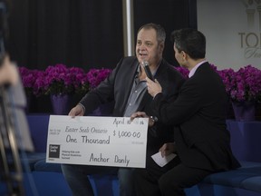 CTV's Bob Bellacicco speaks with Paul Brisebois from Anchor Danly as he presents a cheque for $1,000 to Easter Seals Ontario at the Easter Seals Telethon at Central Park Athletics, Sunday, April 10, 2016.