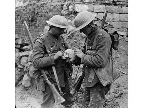 Canadian soldiers examine a skull found on battlefield of Vimy Ridge in April 1917.