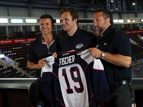 Christian Fischer, is given a Spitfires Jersey by head coach Rocky Thompson (left) and GM Warren Rychel (right) during a press conference at the WFCU Centre in Windsor on Monday, Aug. 24, 2015.