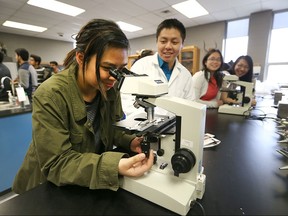 Vincent Massey Secondary School student Lalaine Torres, 17, looks through a microscope during the the third annual Trends in Forensic Science conference, in cooperation with Wayne State University,  hosted at by the University of Windsor on April 8, 2016.