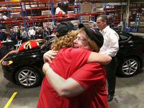 Marlene Klimchak, right, receives a hug from a Gates Corporation co-worker after Klimchak won a brand new Ford Fusion car on April 8, 2016.