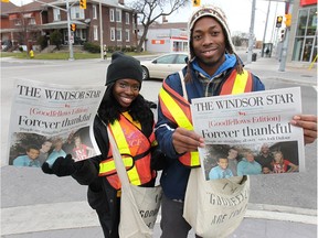 WINDSOR, ON. NOV. 27, 2014. Goodfellows and University of Windsor track team members Esinam Ayesu-Attah (L) and Arren Yound sell newspapers on Wyandotte St. W. in Windsor, ON. on Thursday, Nov. 27, 2014.  (DAN JANISSE/The Windsor Star)