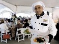 Don Kumarasinghe, owner of Chef Don's 3D Live Catering in Windsor, holds up some of the food served at the annual Gourmet Gardens fundraiser/gala for the Children’s Aid Society at Sprucewood Shores Estates Winery in Amherstburg, Ont. in this file photo.