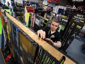 Ryan Coughlin organizes hockey sticks at Perani's Hockey World Canada in Windsor on Monday, April 11, 2016. The store saw increased sales during the CARHA Hockey World Cup.