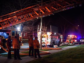 Crews watch as the boom is extended on one of the fire trucks in the area of 768 Indian Rd. in Windsor, Ont., on April 5, 2016.