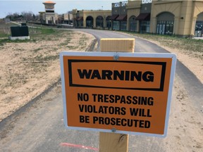 A No Trespassing sign is shown on the trail beside Herb Gray Parkway near Windsor Crossing.