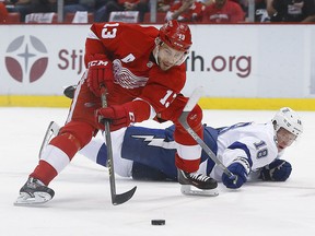 Tampa Bay Lightning left wing Ondrej Palat (18) tries to defend Detroit Red Wings center Pavel Datsyuk (13) duringh the first period of Game 4 in a first-round NHL hockey Stanley Cup playoff series, Tuesday, April 19, 2016, in Detroit.