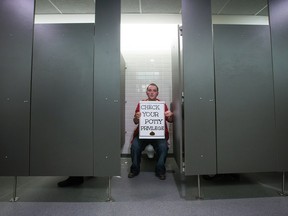 Gender studies major Marlena Boyle participates in a sit-in protest in a men's washroom at Simon Fraser University in Burnaby, B.C., on Wednesday February 18, 2015. A group of transgender, gender-variant, and other students occupied washrooms on campus in an effort to bring awareness to what protesters say is a lack of gender inclusive washrooms.