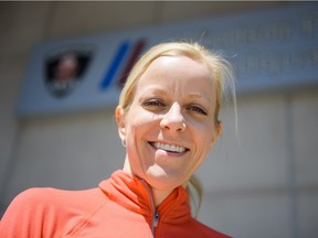 Melanie Baker takes a break during training for the Boston Marathon on April 14, 2016 outside of the Windsor police headquarters where she works in Windsor, Ontario.