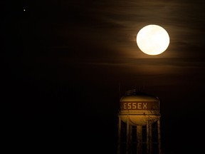 The moon rises over the Town of Essex water tower, Tuesday, Feb. 23, 2016.