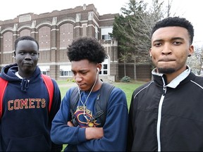 Catholic Central High School students, from left, Ramkel 'Kels' Wal, 17, Rello Grant, 16, and Jojo Cimpean, 19, discuss the arrest of their teammate, Jonathon Nicola, while outside Catholic Central High School, Thursday, April 21, 2016.
