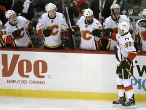 Calgary Flames congratulate teammate Patrick Sieloff (50) after the former Windsor Spitfire scored against the Minnesota Wild during the third period of an NHL hockey game Saturday, April 9, 2016, in St. Paul, Minn. The Flames won 2-1.