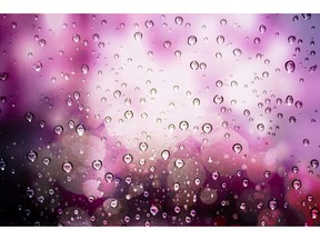 Raindrops on glass. Purple background. Photo by fotolia.com.