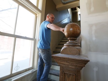 Bill Rawlings, from Rawlings Studio, puts the finishing touches on shelves at a new cafe that will open at the old Canada Post office on Sandwich Street and Mill Street in Windsor, Ont. on April 15, 2016.