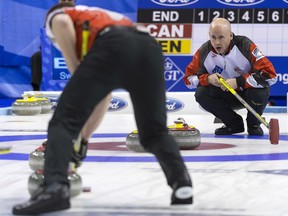Canada's skip Kevin Koe, right, calls a shot during a play-off game between Canada and Denmark, at the World Men's Curling Championship 2016 in the St. Jakobshalle arena in Basel, Switzerland, on Friday, April 8, 2016.