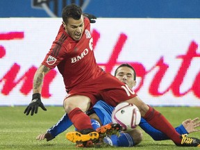 Montreal Impact's Dilly Duka, bottom, challenges Toronto FC's Sebastian Giovinco during second half MLS soccer action in Montreal, Sunday, October 25, 2015.