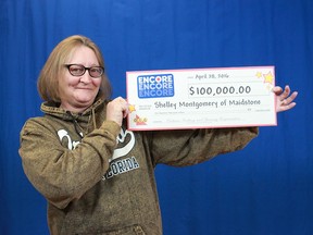 Shelley Montgomery of Maidstone holds up the $100,000 prize cheque she won by playing Encore.