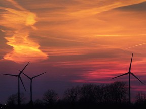 he sun sets on April 14, 2016, over windmills near Essex, Ont.