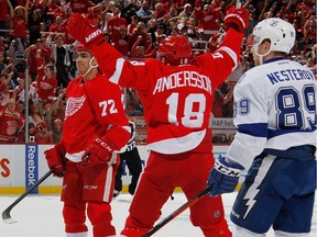 Andreas Athanasiou #72 of the Detroit Red Wings celebrates his second-period goal with Joakim Andersson #18 while playing the Tampa Bay Lightning in Game 3 of the Eastern Conference quarter-finals at Joe Louis Arena on April 17, 2016.