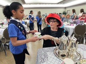 Abbey Grineau, 9, gets a cup of tea from Betty Clinansmith during the annual Wishing Well Tea for Girl Guides on Saturday, April 16, 2016, at Our Lady of the Atonement Family Centre in Windsor.