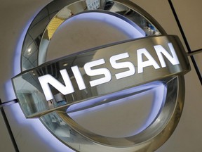 The emblem of Nissan Motor Co. shines on a wall of the company's showroom in Tokyo on June 25, 2013.