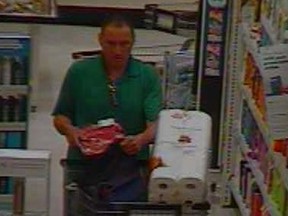 A male suspect places meat into his backpack at the Real Canadian Super Store on Dougall Avenue in Windsor, Ont. on Monday, April 18, 2016.