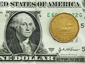 This September 2007 photo shows Canadian loonie and the U.S. dollar.