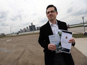 Greg Atkinson, a City of Windsor senior planner, stands by a vacant brownfield site on Riverside Drive on Monday. The site's owners are taking advantage of a city program that will help with cleanup costs.