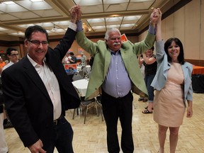 NDP MP Brian Masse and MPP Percy Hatfield, centre, congratulate Lisa Gretzky on her victory in the Windsor West riding at the Caboto Club in Windsor on Thursday, June 12, 2014.