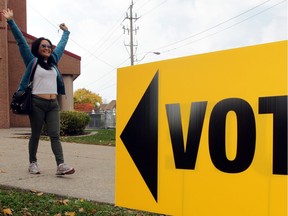 Windsor, ON. October 27, 2014 --  Happy voter Godgela Luig raises her arms after voting at Dougall Avenue Publis School on Election Day Monday October 27, 2014. (NICK BRANCACCIO/The Windsor Star)