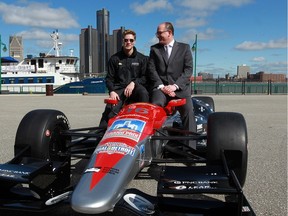 Indycar driver Josef Newgarden, left, chats with Windsor Mayor Drew Dilkens during Chevrolet Belle Isle Grand Prix news conference at Windsor's Festival Plaza  on Tuesday April 12, 2016. The pair was sitting atop a Penske Racing show car. The Indy 500 race car version is usually equipped with a 2.2-L, twin-turbo V-6 Chev engine, pumping out 750 horsepower and 12,000 r.p.m.