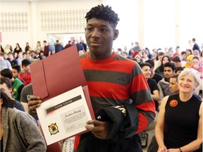 Jonathan Langley displays his Windsor Fire Service citizen's citation that was presented to him by fire Chief Bruce Montone in front of the student body at Westview Freedom Academy in Windsor, Ont., on April 16, 2016.