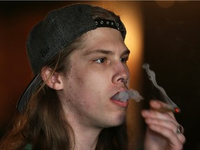 Windsor, Ontario. April 20, 2016 -- Jonah Komon, 22, smokes at Higher Limits on Ouellette Avenue in Windsor as the federal government takes steps to legalize marijuana within one year, Wednesday April 20, 2016. (NICK BRANCACCIO/Windsor Star)