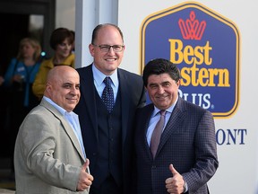 Thumbs up from co-owners Shmuel Farhi, left, and Darko Vranich of Vrancor Group who pose with Windsor Mayor Drew Dilkens at the unveiling of extensive renovations at Best Western Plus Waterfront Hotel May 3, 2016. The hotel features a newer, modern look and retains impressive views of the Detroit River and skyline.