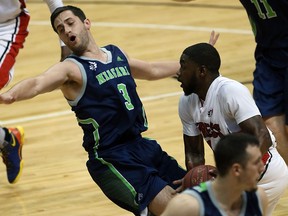 Niagara River Lions Sammy Zeglinski, left, reacts as Express Tony Bennett drives to the basket in NBL Canada playoff action from WFCU Centre May 04, 2016. Bennett scored on the play and no foul was called.