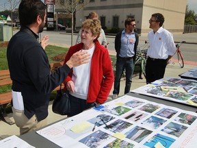 Tecumseh resident Aubrey Bell chats with Town of Tecumseh planners Enrico De Cecco, left, Brian Hillman, behind, Chad Jeffery and Antonio Gomez-Palacio, right, during a "pop-up event" to discuss changes to the town streetscape May 11, 2016.