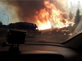 Wildfires like Highway 63 southbound as residents of Fort McMurray leave the downtown area on Tuesday May 3, 2016. Robert Murray/Fort McMurray Today/Postmedia Network