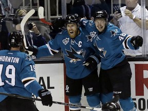 San Jose Sharks' Joe Pavelski, center, celebrates his goal with teammates Tomas Hertl, right, and Joe Thornton (19) during the first period in Game 6 of the NHL hockey Stanley Cup Western Conference finals against the St. Louis Blues Wednesday, May 25, 2016, in San Jose, Calif. (AP Photo/Jeff Chiu)